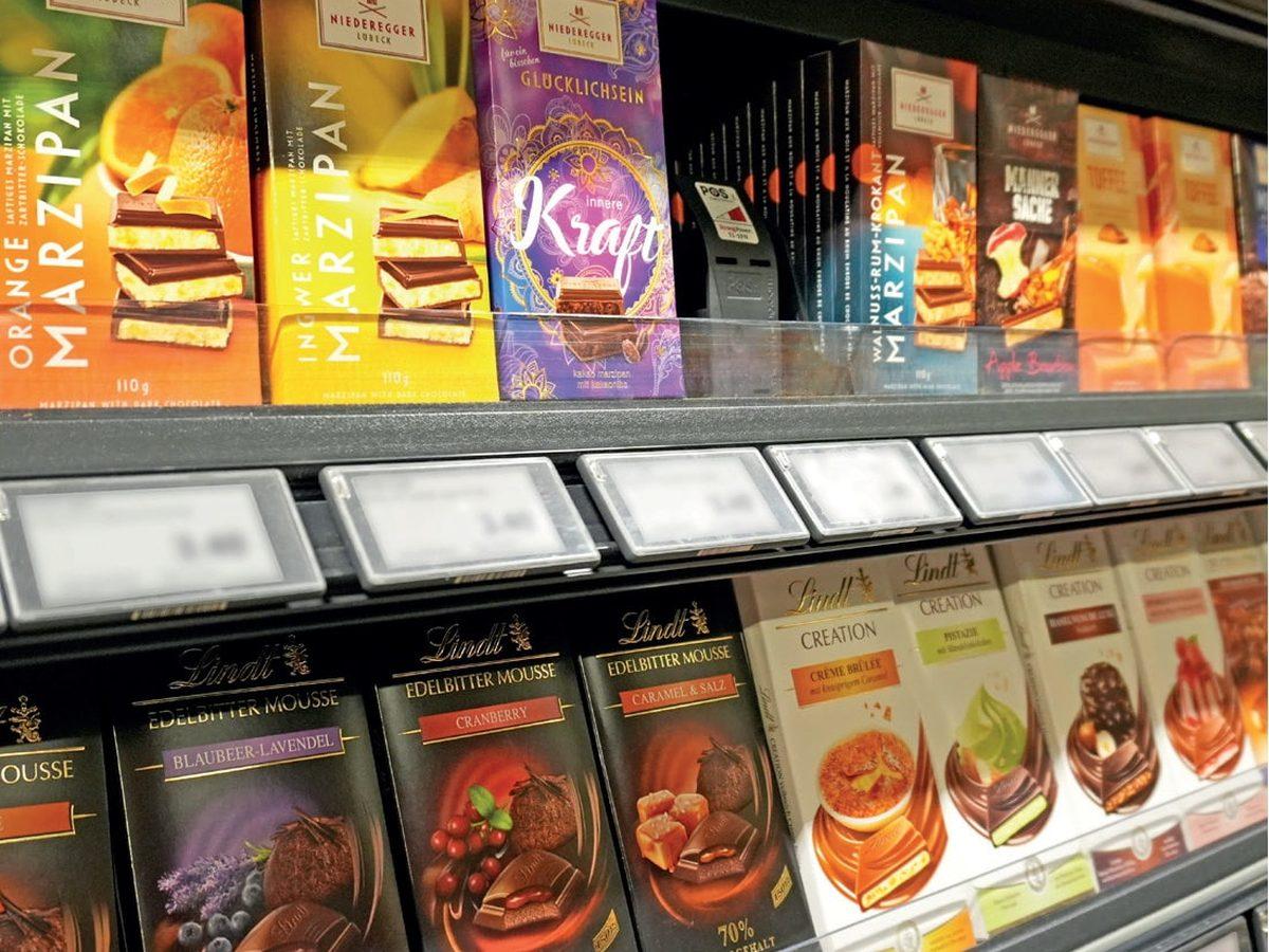 Boxed chocolate bars kept at the shelf front by POS-T Vincent pushers