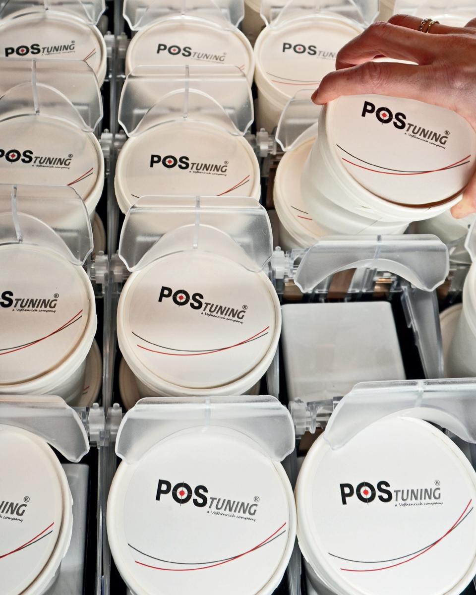 POS-T Skadi Lift installed in grocery chest freezer — ice cream cups elevated to grab height, fully visible and front-facing