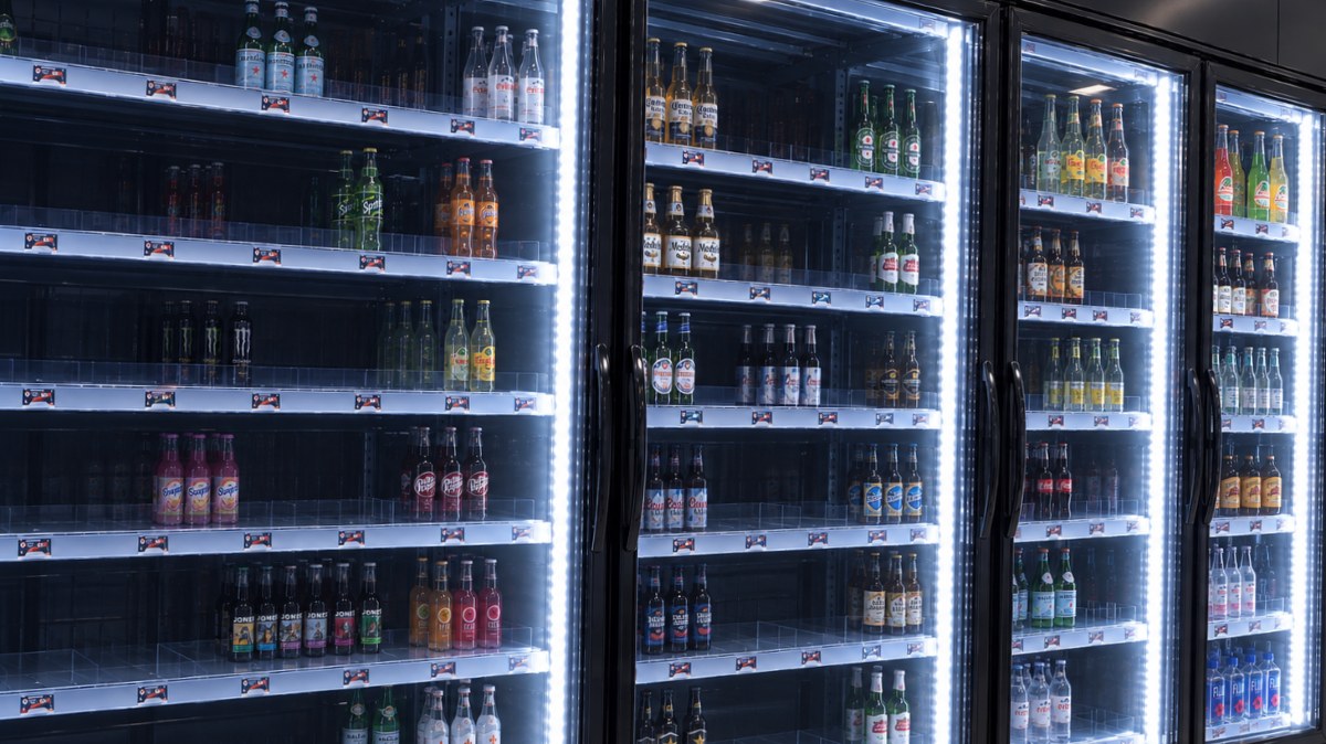 Before: Disorganized beverage cooler shelf with recessed stock and cluttered bottles