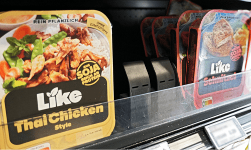 Two pusher units installed side-by-side on gondola shelf with wide products front-faced